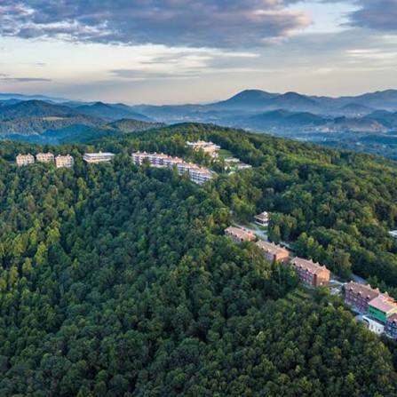 Aerial view of the retreat center on a forested mountain ridge